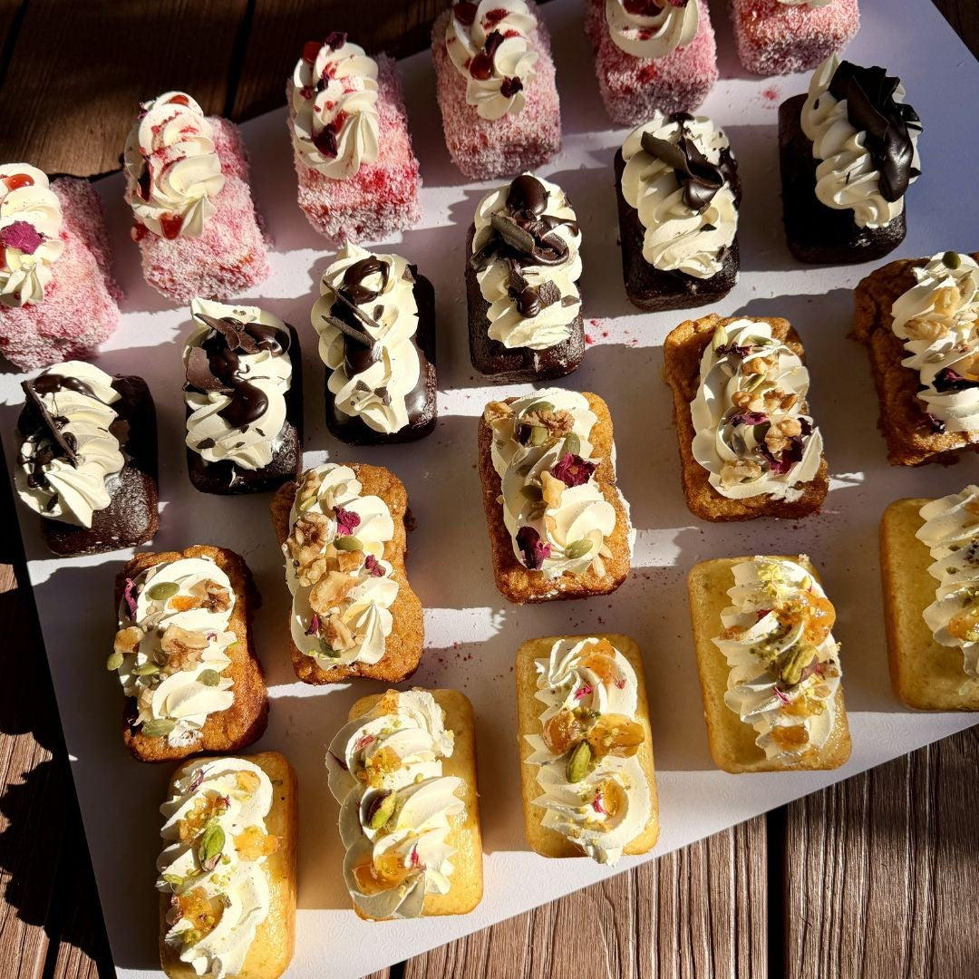 Assorted small desserts on a wooden surface