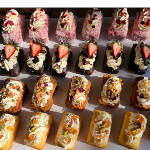 Assorted pastries with different fillings and toppings on a white surface.