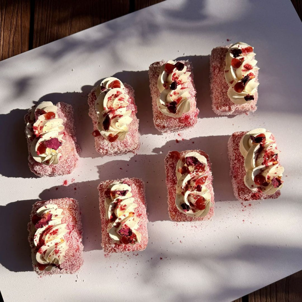 Small dessert pastries with cream and fruit on a white surface
